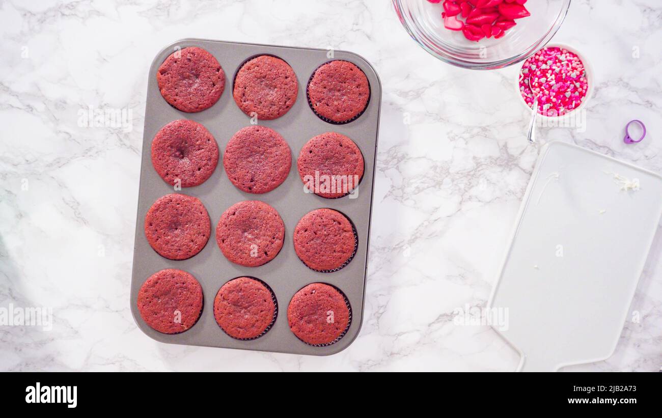 Flat lay. Step by step. Cooling red velvet cupcakes on a kitchen drying rack. Stock Photo