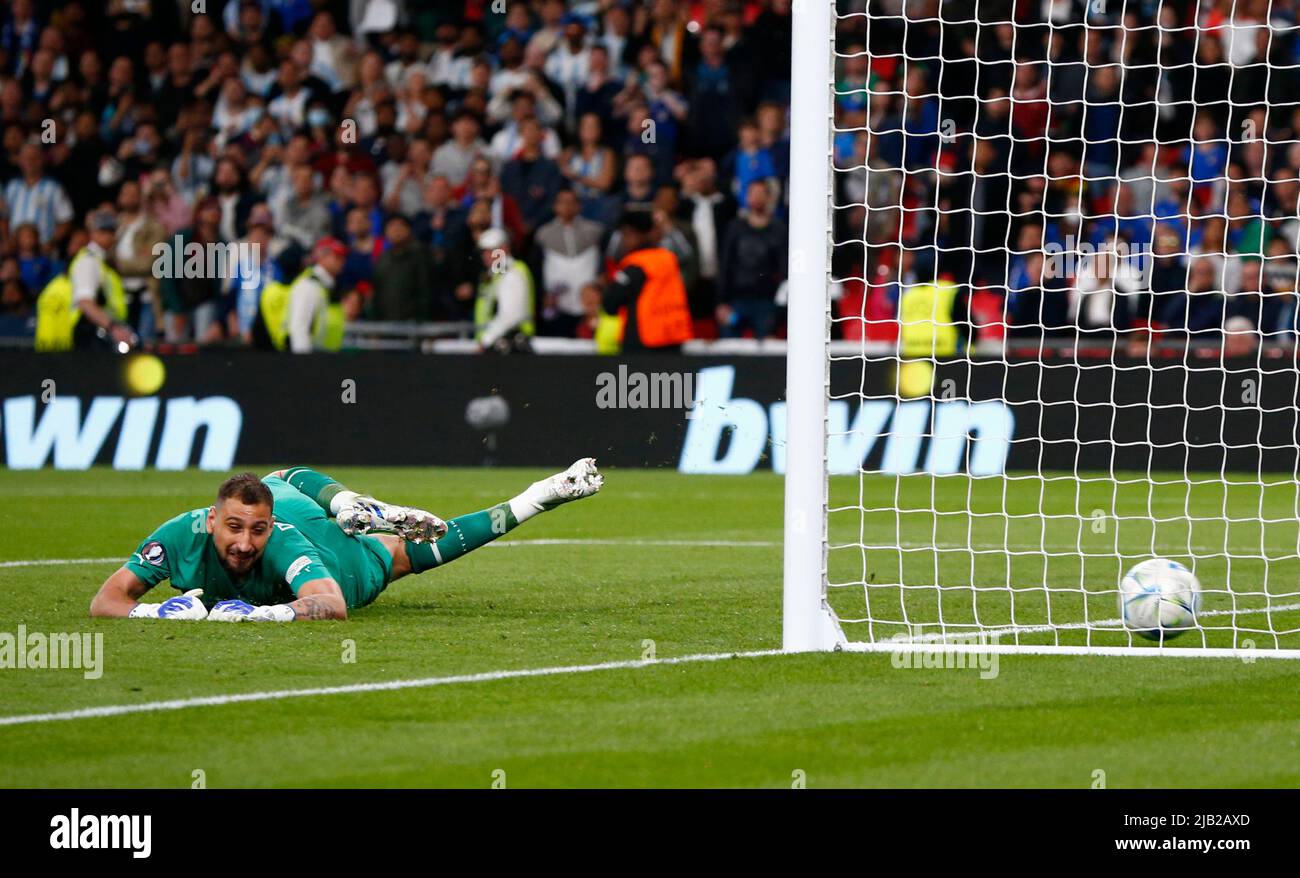 LONDON, ENGLAND - JUNE 01: Gianluigi Donnarumma of Italy gets beaten by Paulo Dybala of Argentina during Finalissima Conmebol - UEFA Cup of Champions Stock Photo