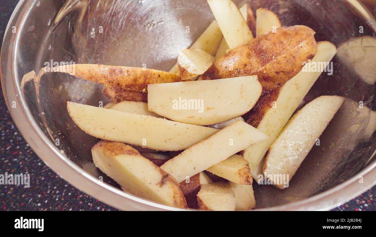 Preparing potato wedges on baking sheet in oven Stock Photo Alamy