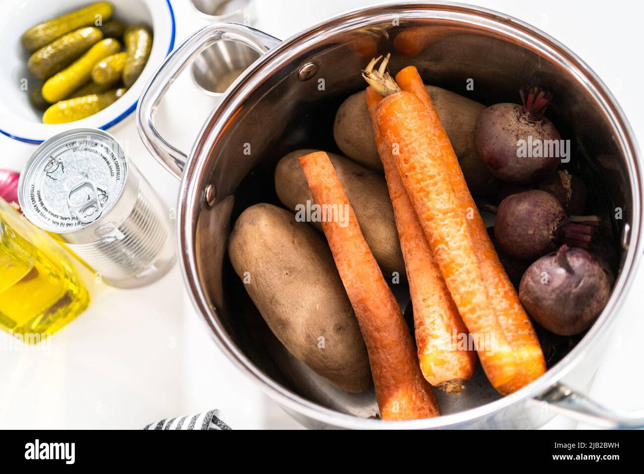 Boiling vegetables in a big cooking pot to make a vinaigrette salad