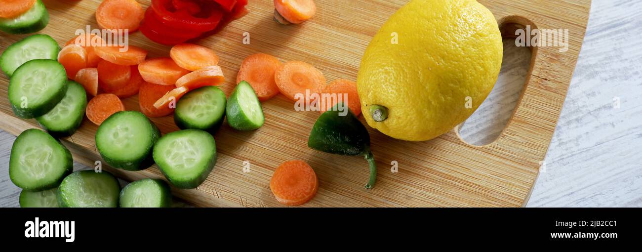 fruits and vegetables on wooden chopper table Stock Photo - Alamy