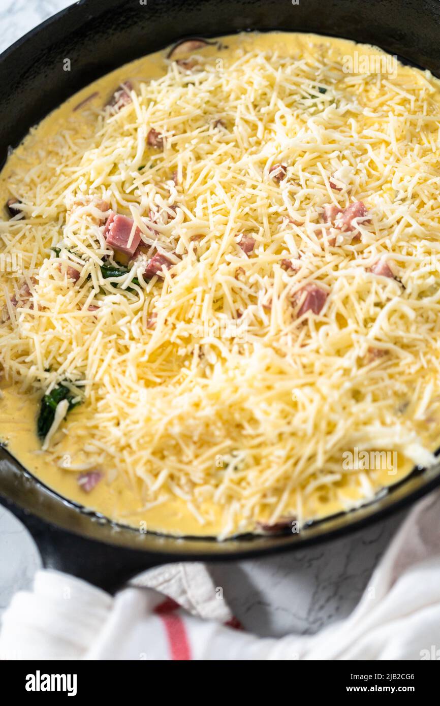 Preparing spinach and ham frittata in cast iron skillet Stock Photo Alamy