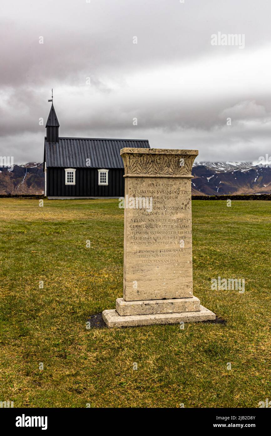 The tiny wooden church Búðakirkja (Iceland) is dating back to the 19th century in a scenic natural area with a lava field. The church was preserved despite the clergy decree of Steinunn Sveinsdottir, who found her final resting place in the cemetery Stock Photo