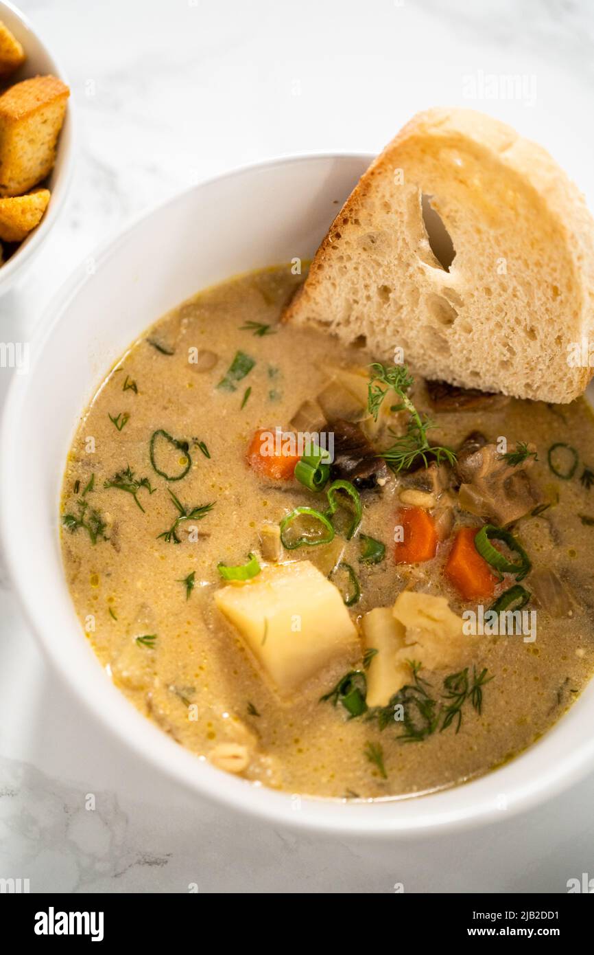 Serving creamy wild mushroom soup made out of dehydrated wild mushrooms