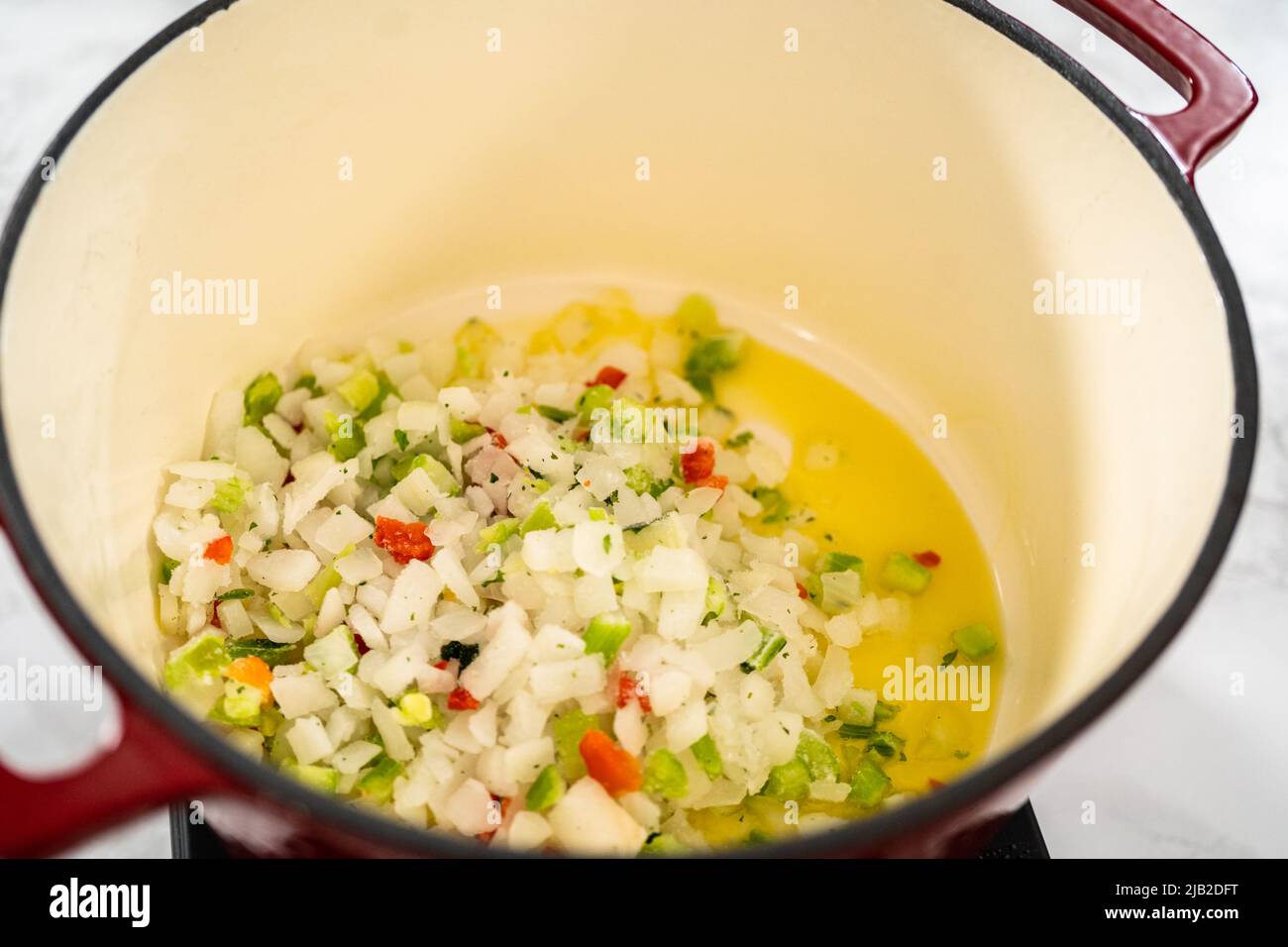 Cooking chicken noodle soup with kluski noodles in an enameled dutch