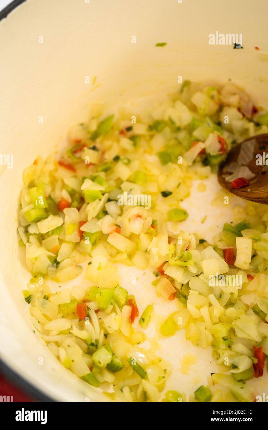 Cooking chicken noodle soup with kluski noodles in an enameled dutch