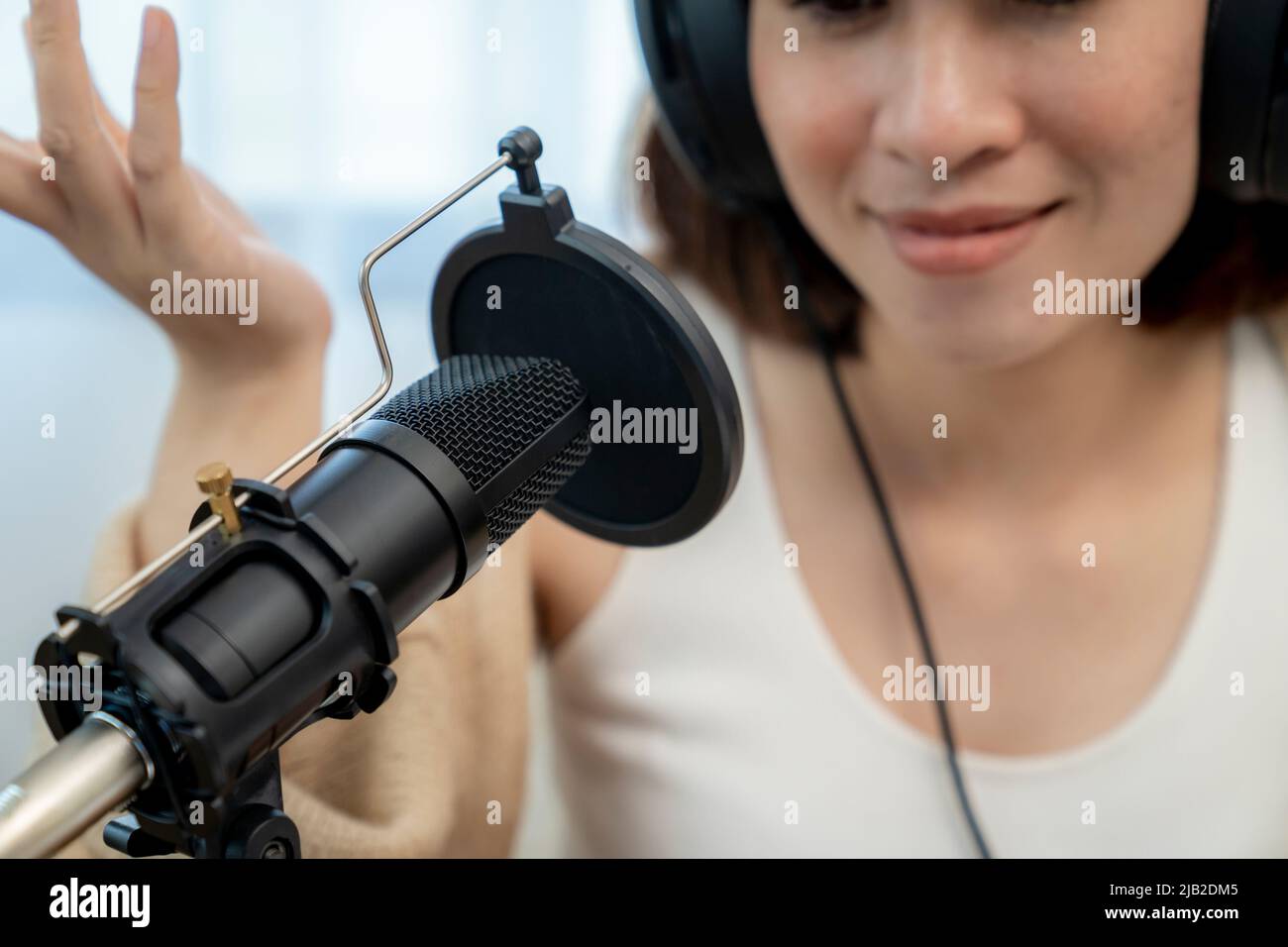 Asian female radio host are streaming talk about audio podcast online at home Stock Photo