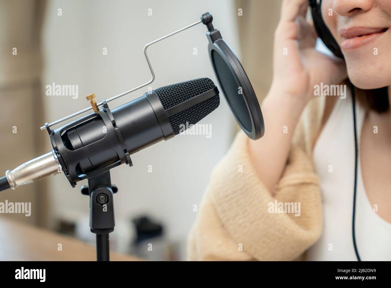 Asian female radio host are streaming talk about audio podcast online at home Stock Photo