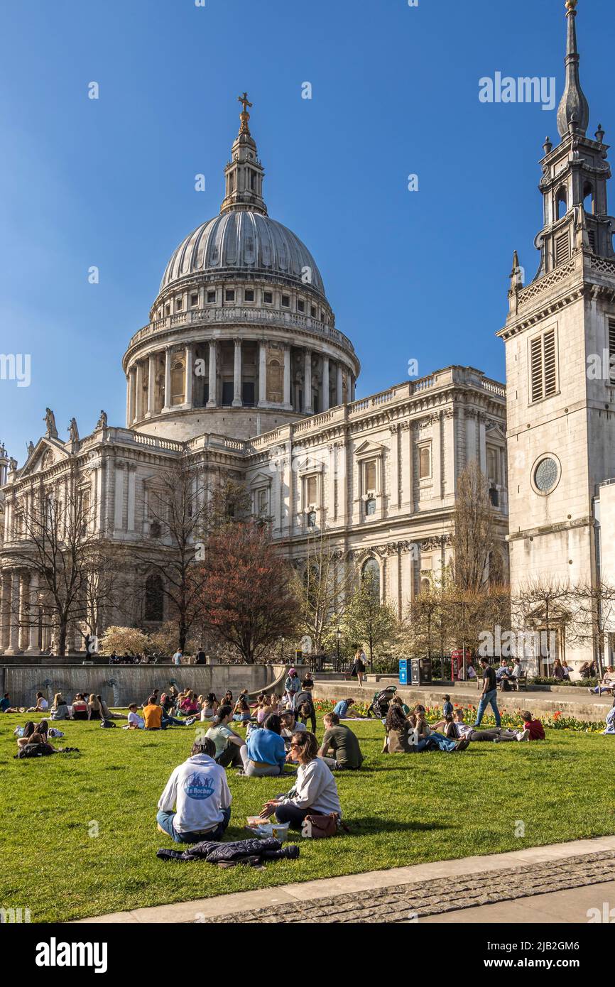 People enjoying the spring sunshine in Festival Gardens at St Paul's Cathedral ,London EC4 Stock Photo