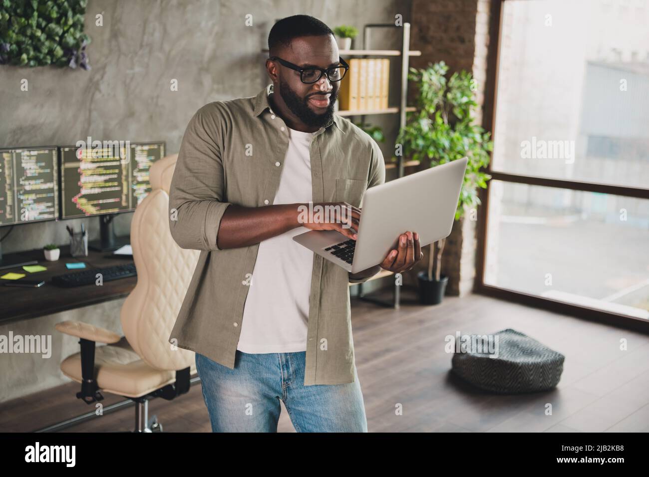 Portrait of attractive experienced guy technician editing web sit eusing laptop data code at workplace workstation indoors Stock Photo