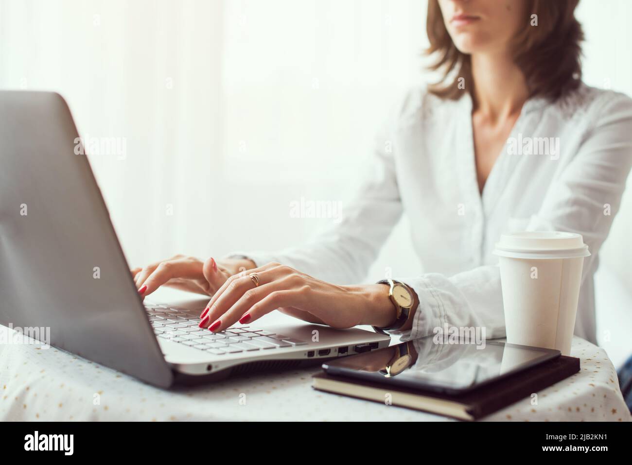 Woman freelancer, student or blogger typing on computer sitting at ...