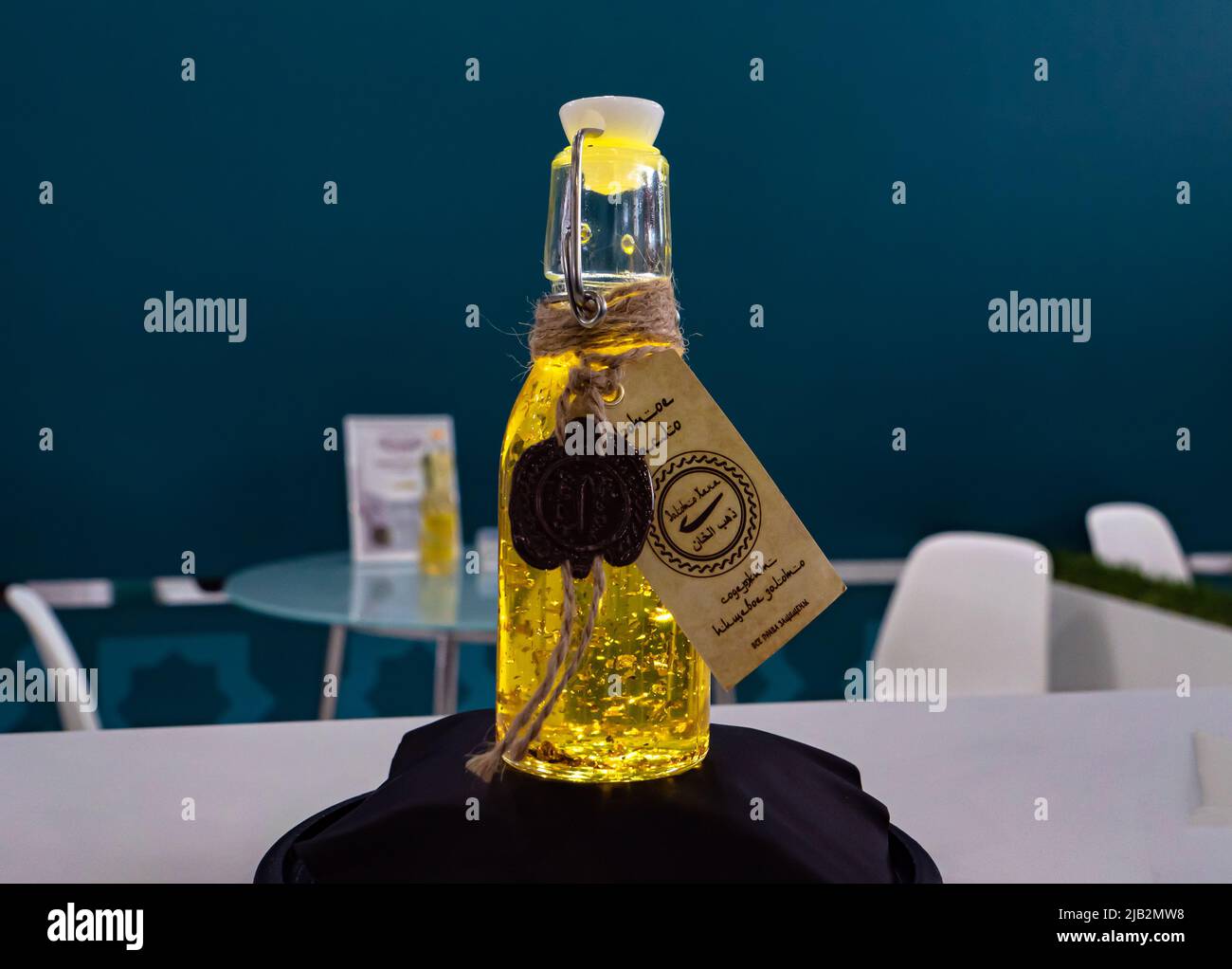 Kazan, Russia. May 19, 2022. A bottle of sunflower oil with pieces of edible gold. Natural sunflower oil. Premium product Stock Photo