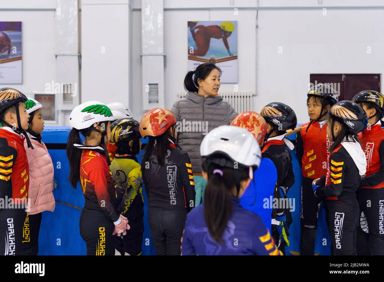 (220602) -- QITAIHE, June 2, 2022 (Xinhua) -- Han Mei, coach of Qitaihe Juvenile's Short-Track Speed Skating Amateur Sports School guides young athletes during a training session at Qitaihe Sports Center in Qitaihe City, northeast China's Heilongjiang Province, May 30, 2022. Qitaihe City in Heilongjiang Province, famed for its short-track speed skating talents, has trained 10 world champions including Yang Yang, Wang Meng and Fan Kexin. Generations of coachs in the city have endeavored to discover and train young talents for short-track speed skating. (Xinhua/Xie Jianfei) Stock Photo