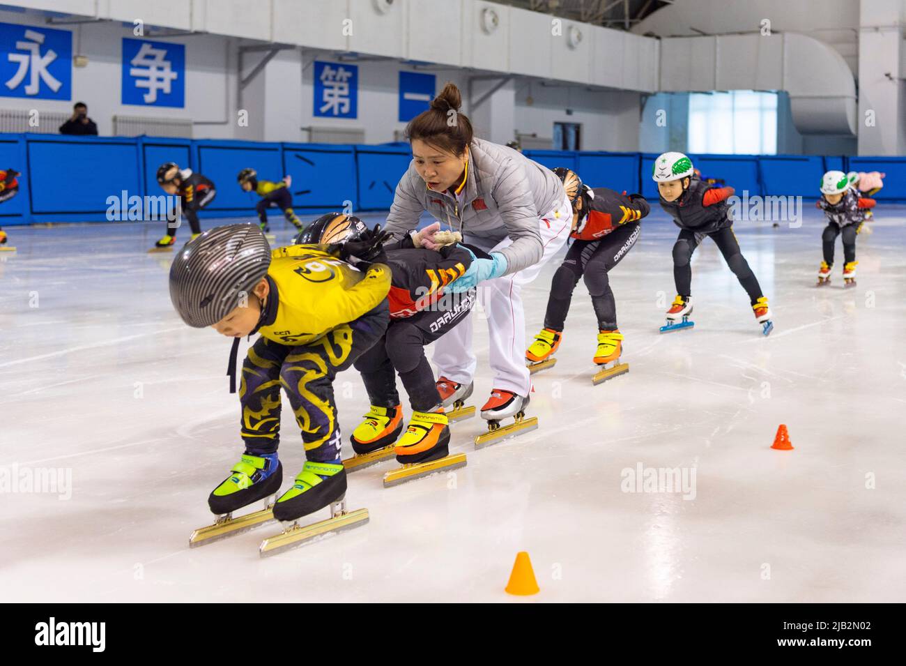 (220602) -- QITAIHE, June 2, 2022 (Xinhua) -- Zhao Xiaobing, coach of Qitaihe Juvenile's Short-Track Speed Skating Amateur Sports School guides young athletes during a training session at Qitaihe Sports Center in Qitaihe City, northeast China's Heilongjiang Province, May 30, 2022. Qitaihe City in Heilongjiang Province, famed for its short-track speed skating talents, has trained 10 world champions including Yang Yang, Wang Meng and Fan Kexin. Generations of coachs in the city have endeavored to discover and train young talents for short-track speed skating. (Xinhua/Xie Jianfei) Stock Photo