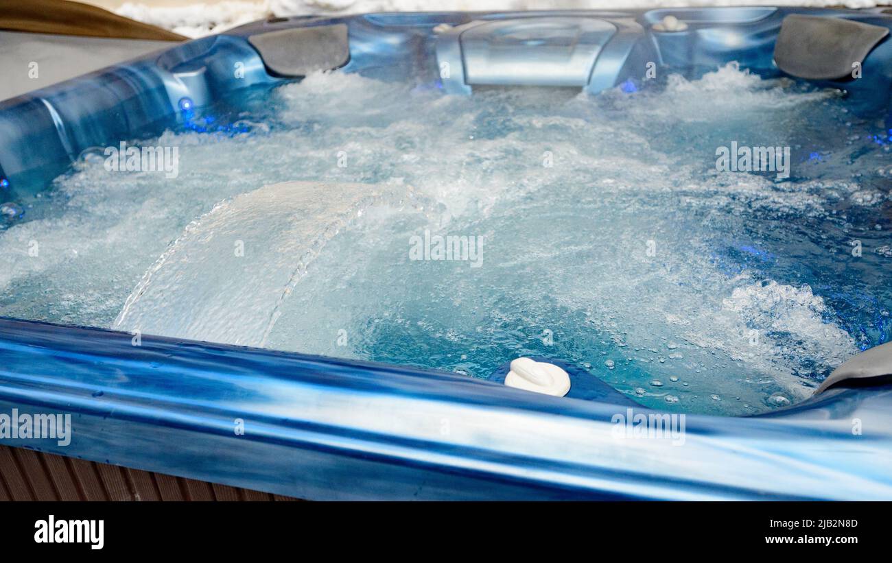 The jacuzzi is gaining water close up, relaxing in the spa, jacuzzi