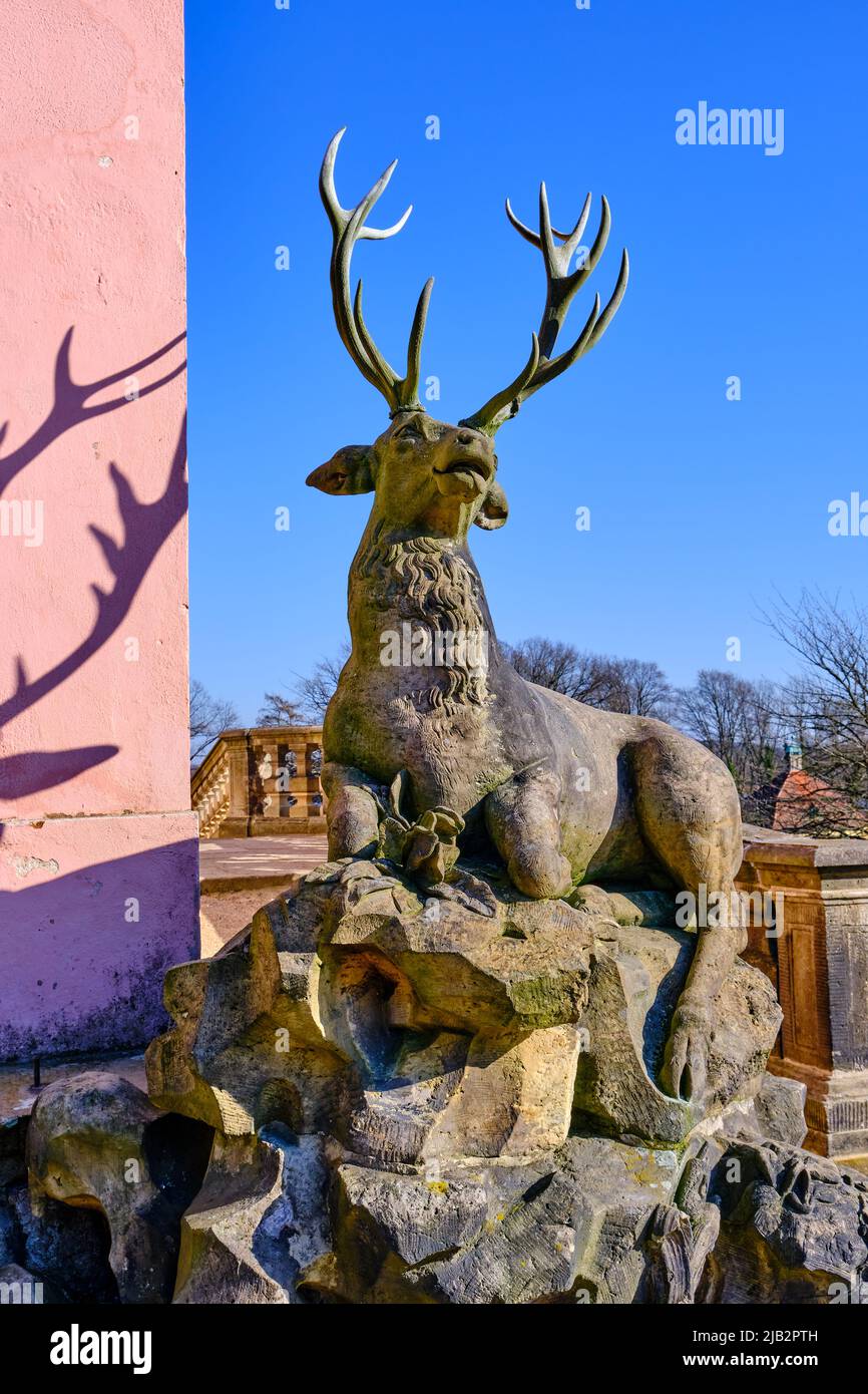Moritzburg outside Dresden, Saxony, Germany, March 1, 2022: Stone sculpture of a stag at the south-west corner of the Pheasant Palace. Stock Photo