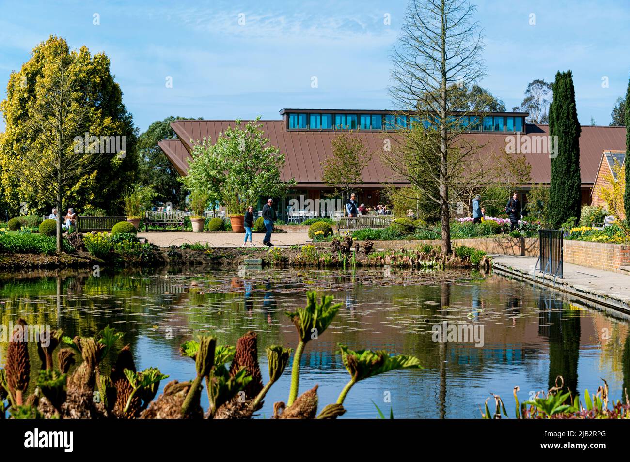 RHS Hyde Hall, the Gardeners Rest restaurant, with the Upper pond in the foreground Stock Photo