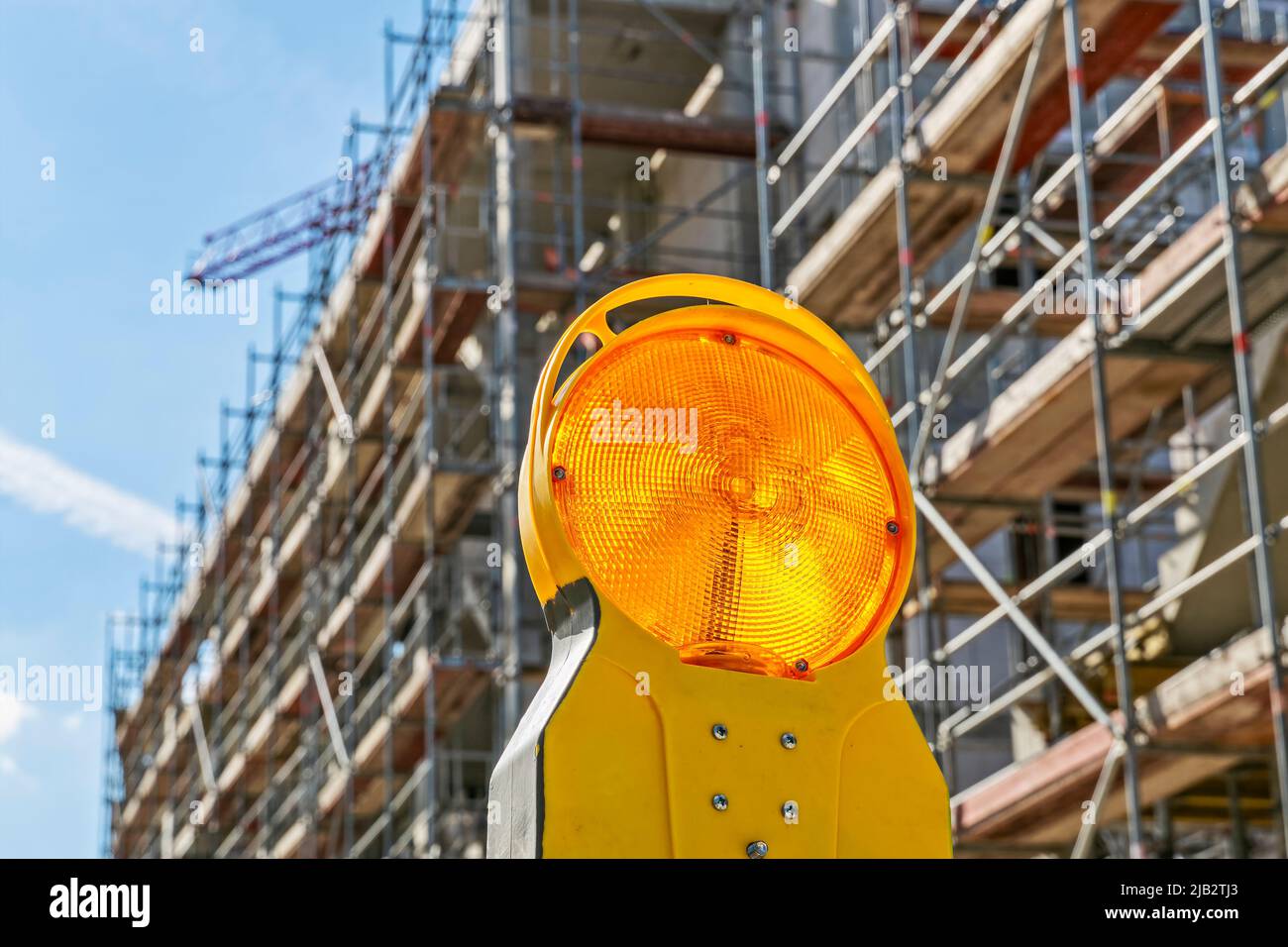 Shell of an apartment building with scaffolding and warning light in the foreground in Bad Homburg (Vickers - Areal) near Frankfurt on the Main Stock Photo