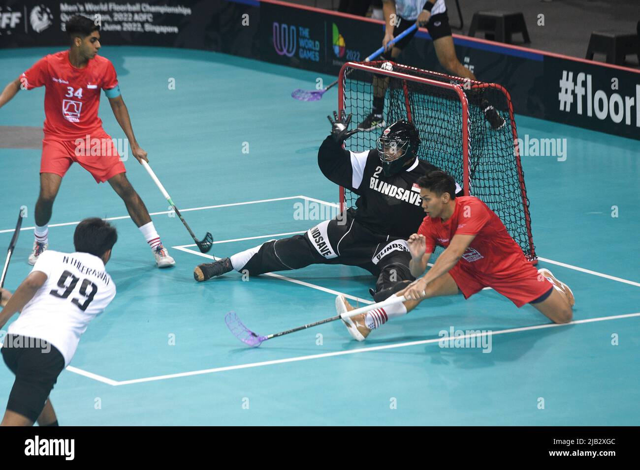 Singapore, AOFC (Asia-Oceania Floorball Confederation) in Singapore. 2nd  June, 2022. Noisoi Theerawat (bottom L) of Thailand scores a goal during a  Group H match at the Men's World Floorball Championships Qualification, 2022