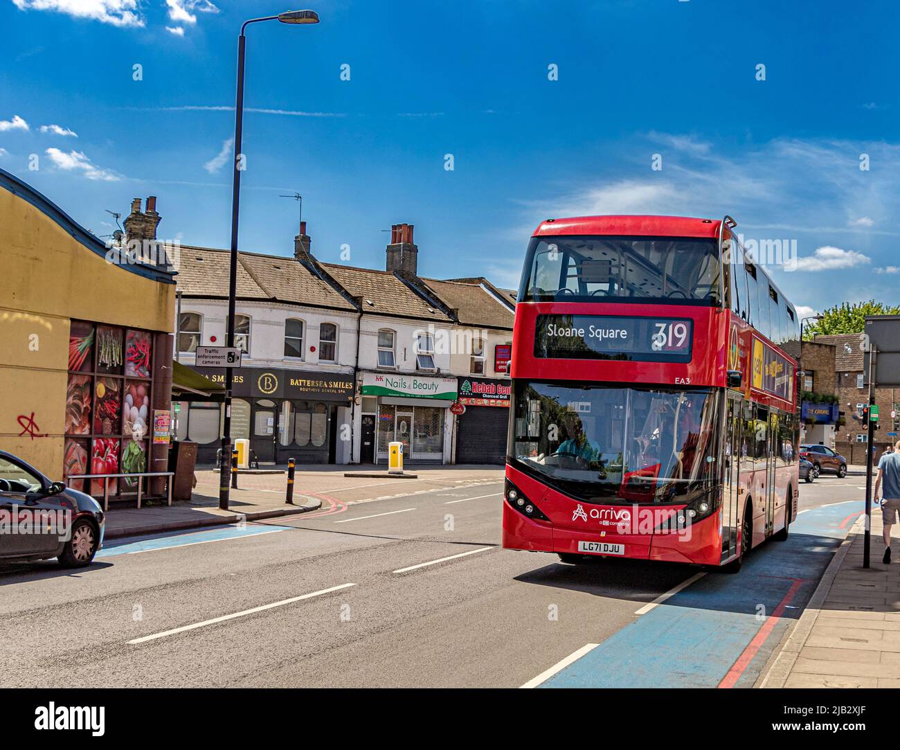A route 319 Electric London bus on route to Sloane Square, makes it's way along Battersea Park Road in SW London ,UK Stock Photo