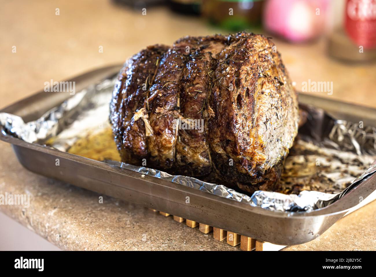 A large prime rib beef roast that was baked and roasted in the oven by a home gourmet chef for a holiday Christmas dinner Stock Photo