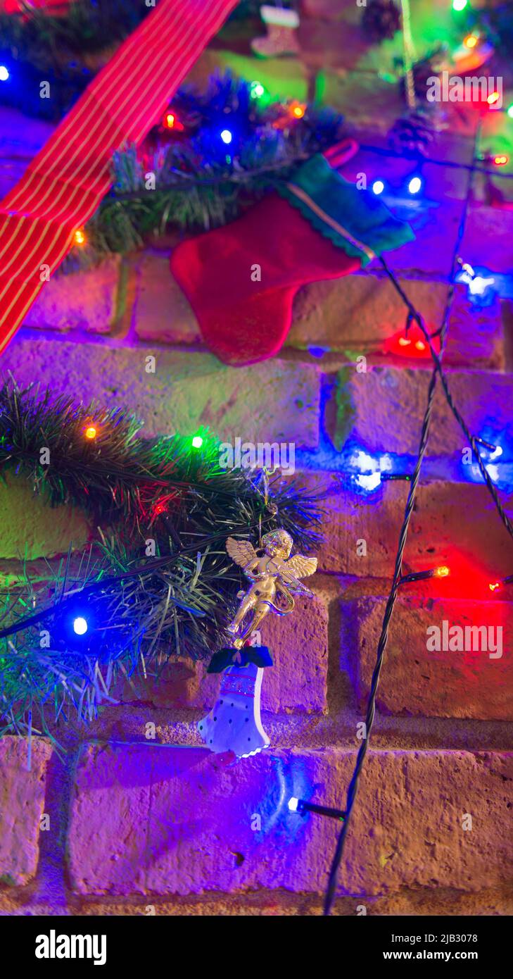 Christmas tree decoration over a brick chimney Stock Photo