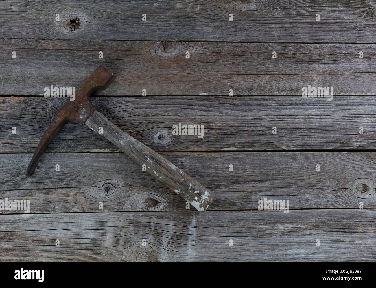 Vintage hammer on aged wooden plank floor boards Stock Photo