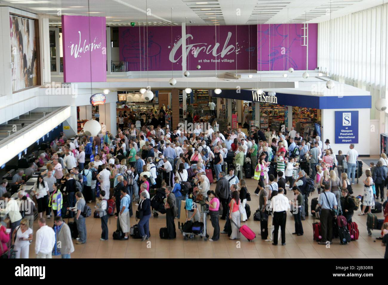 Glasgow Prestwick Airport, Prestwick, Ayrshire, Scotland, UK. Re branded as Pure Dead Brilliant. Photo shows crowds of holidaymakers in the terminal building Stock Photo