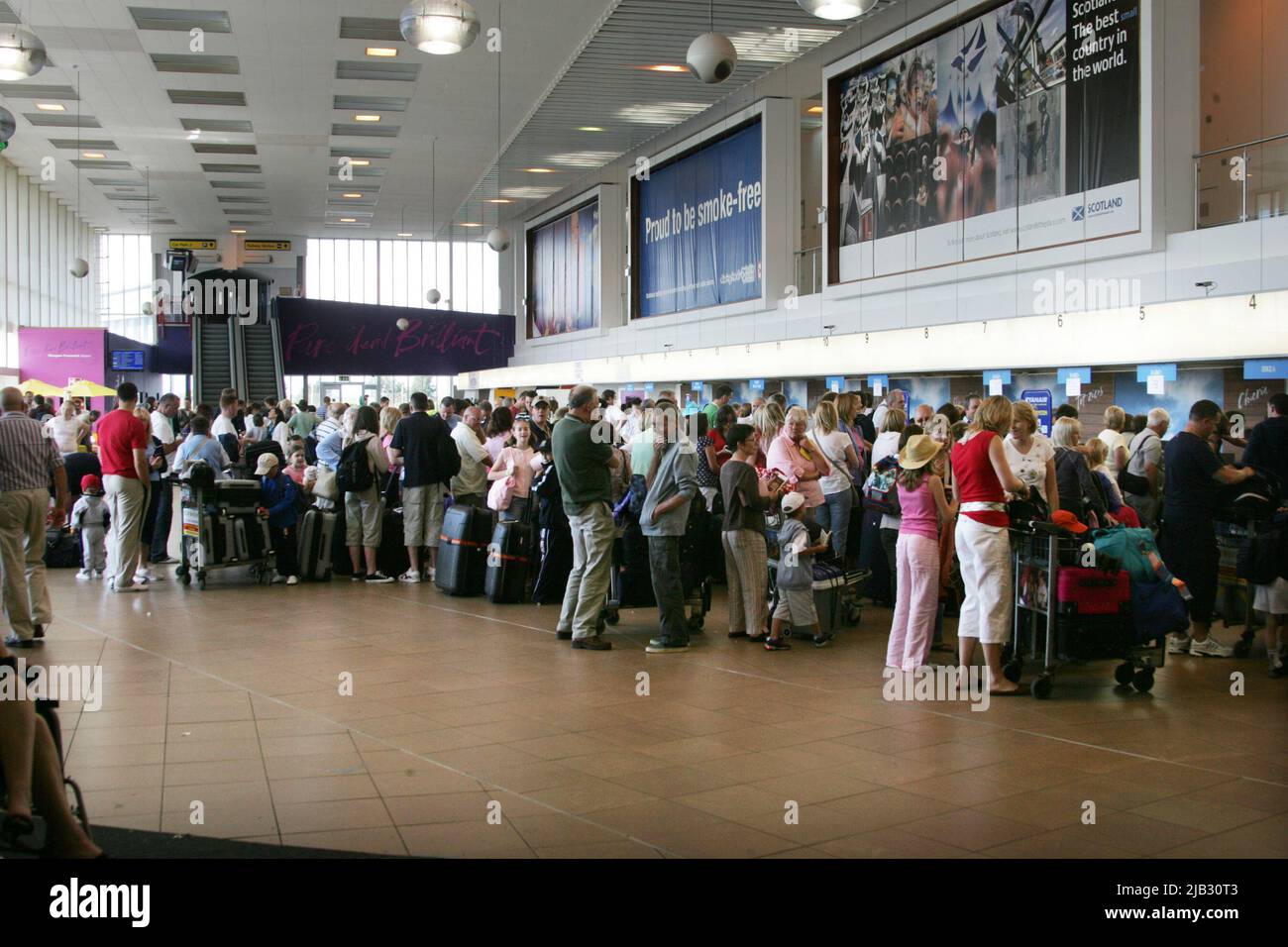 Glasgow Prestwick Airport, Prestwick, Ayrshire, Scotland, UK. Re branded as Pure Dead Brilliant. Photo shows crowds of holidaymakers in the terminal building Stock Photo