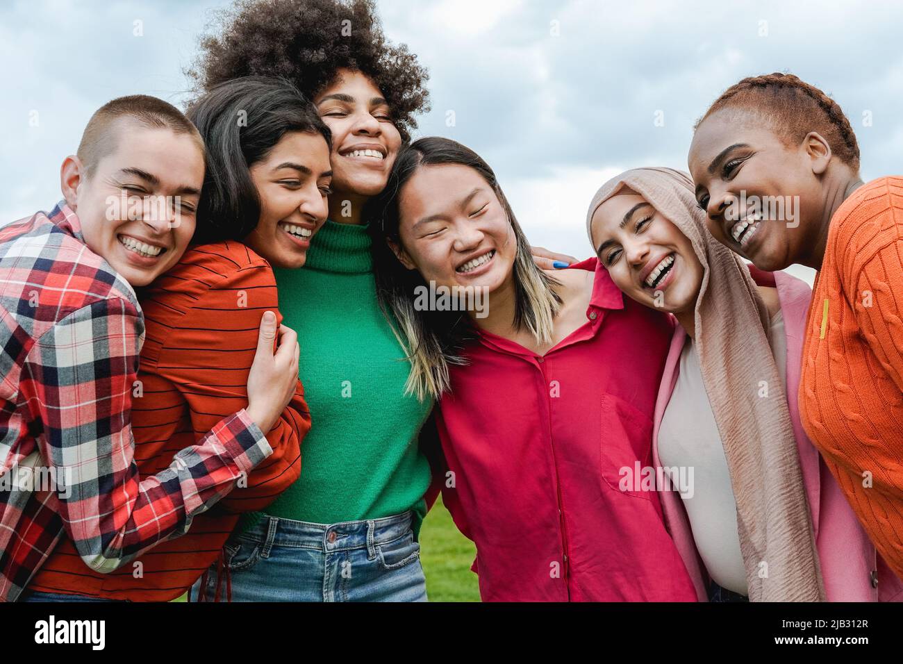 Multiethnic young women having fun together outdoor - Focus on muslim girl face Stock Photo