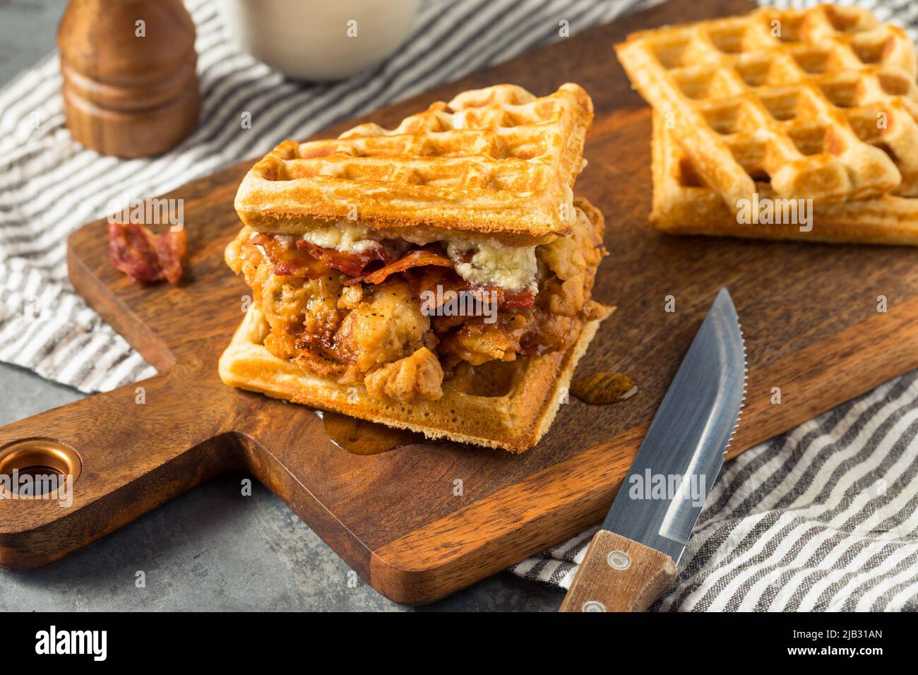 Homemade Chicken and Waffle Sandwich with Bacon and Syrup Stock Photo