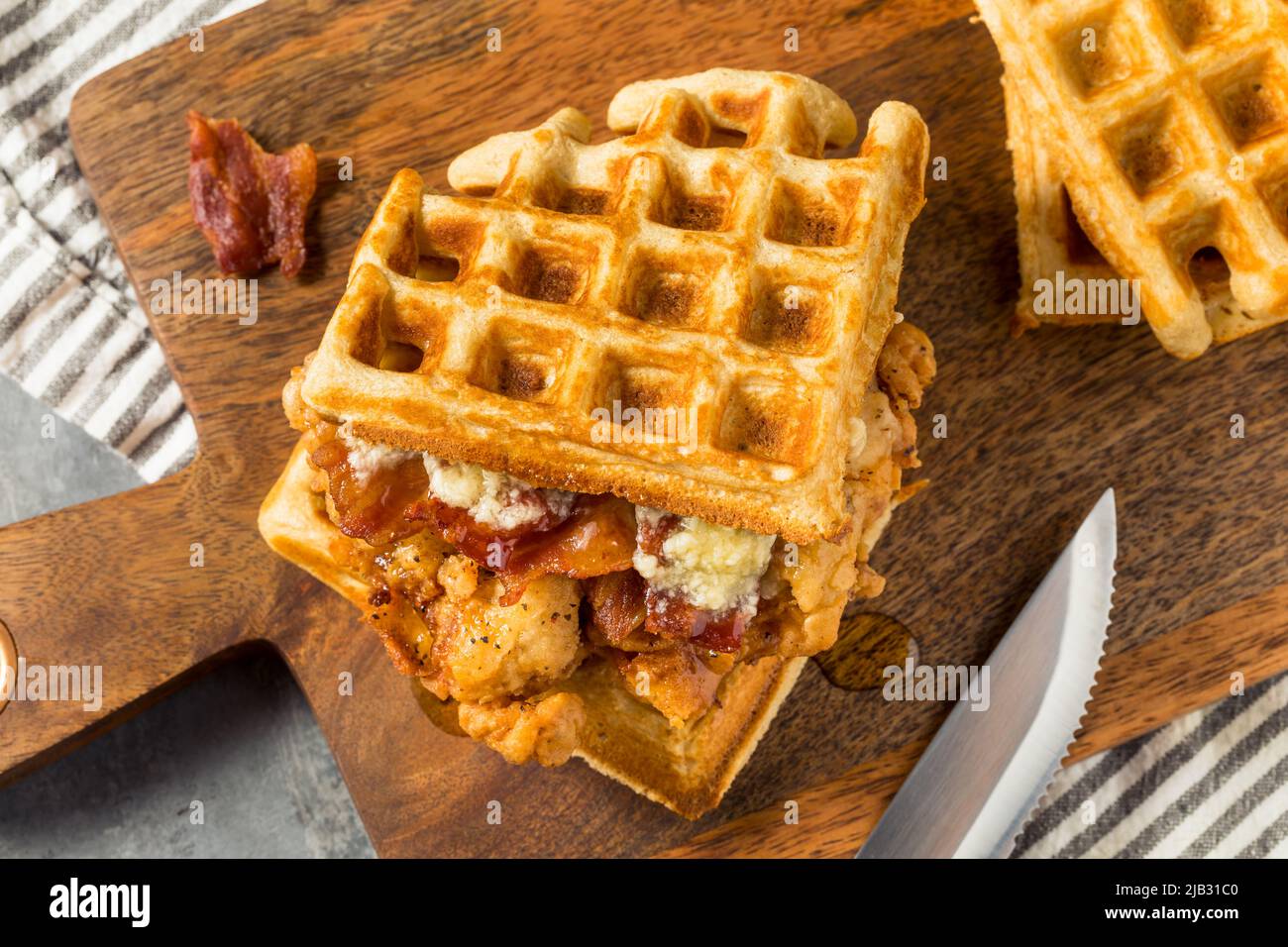 Homemade Chicken and Waffle Sandwich with Bacon and Syrup Stock Photo