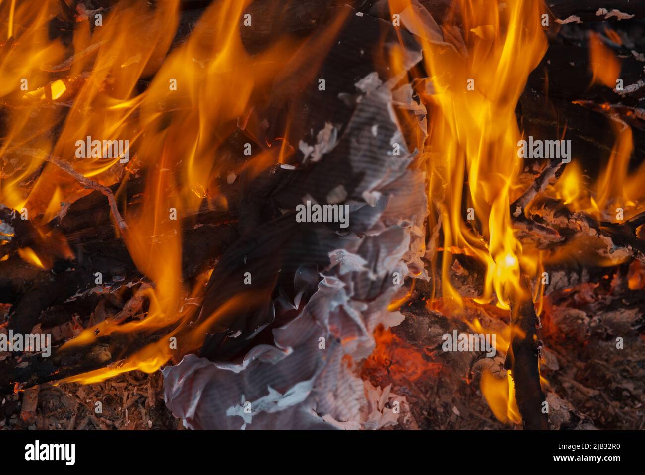 Bonfire. The flame of fire burns sheets of paper, books or documents. Elimination of evidence. Stock Photo