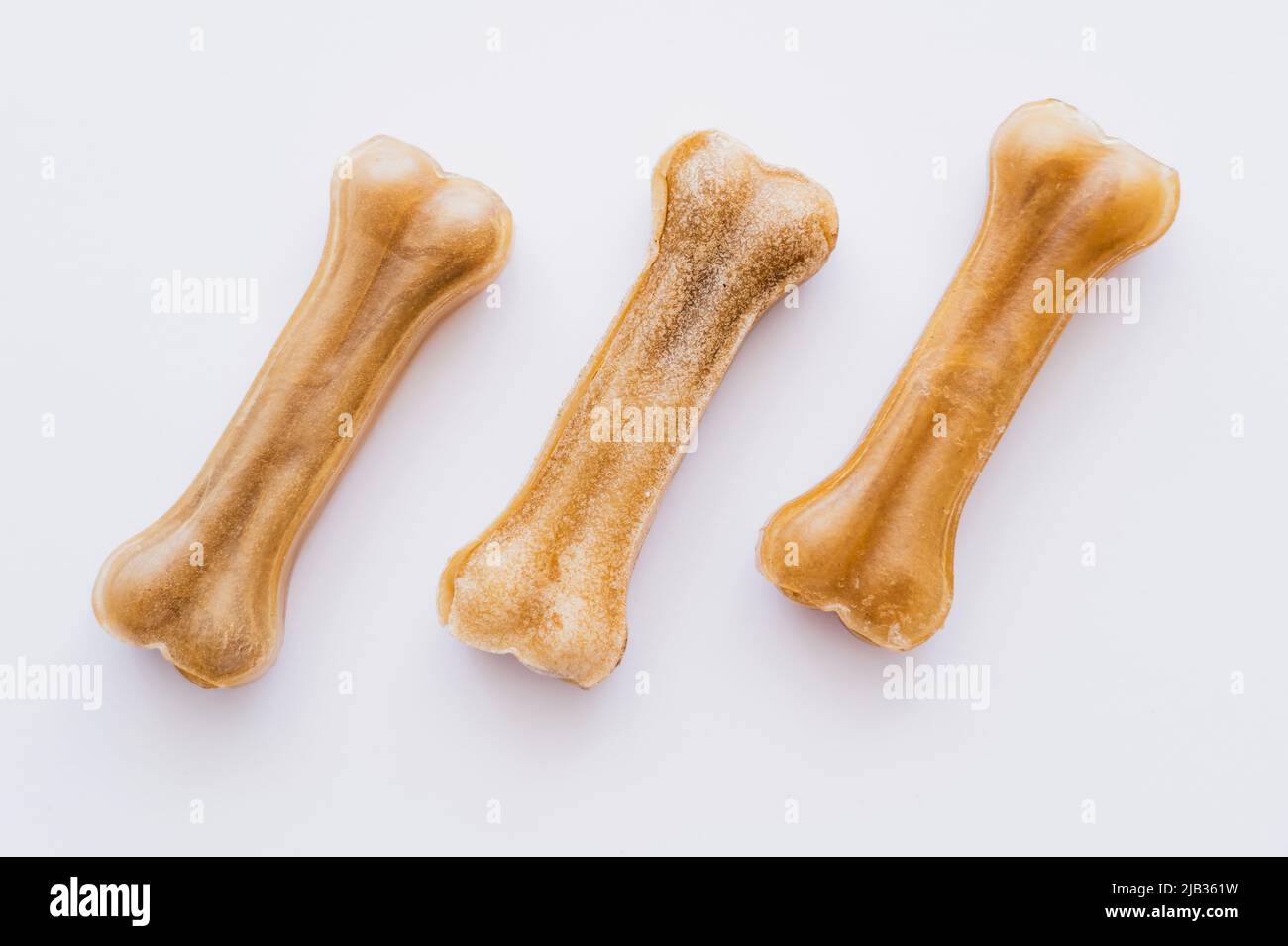 flat lay of bone shaped pet treats isolated on white Stock Photo