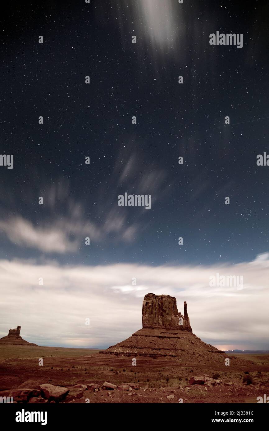 AZ00436-00....ARIZONA - Stars and clouds over West Mitten Butte in Monument Valley Navajo Tribal Park. Stock Photo