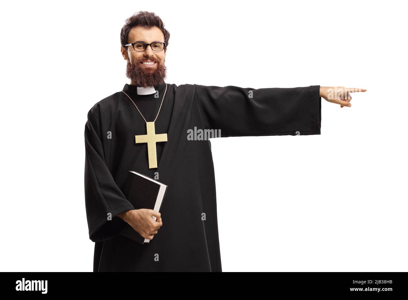 Priest holding a bible and pointing to the side isolated on white background Stock Photo