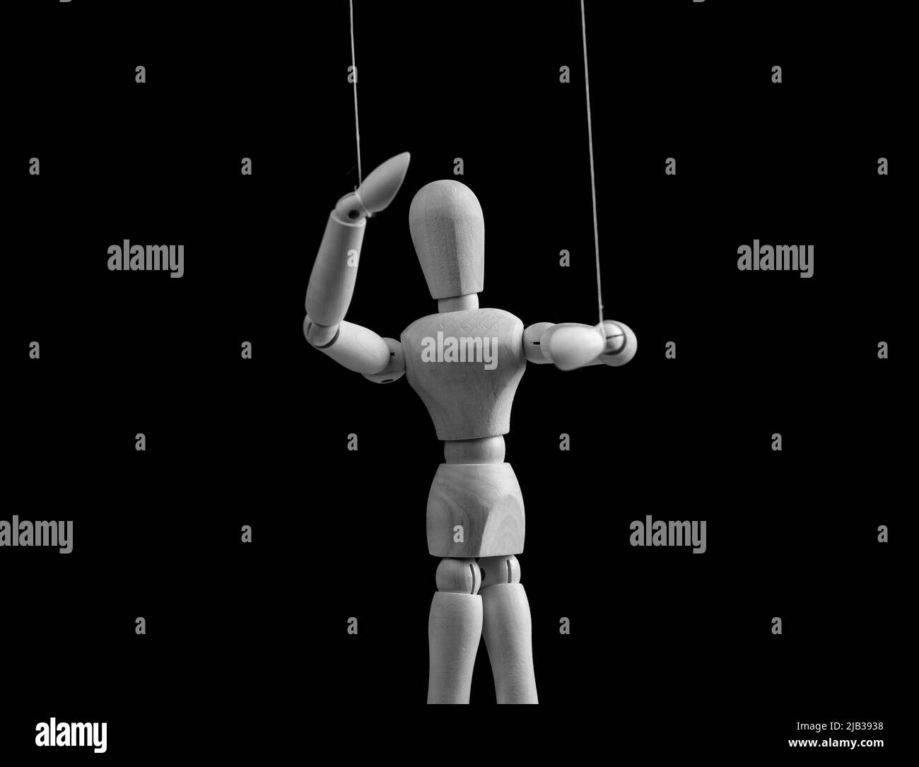 Puppet on strings. Exploit, control, abusive relationship concept. Alcohol, drug, gambling, internet addiction. Doll dependent on puppeteer. Black and white. High quality photo Stock Photo