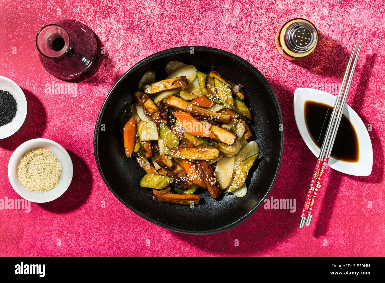 rice cake with vegetables in the plate. served with soy sauce Stock Photo