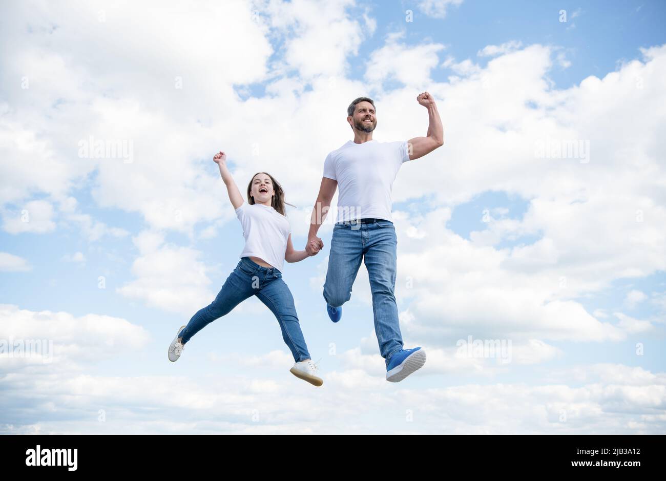 happy father and daughter jump in sky. happiness Stock Photo - Alamy