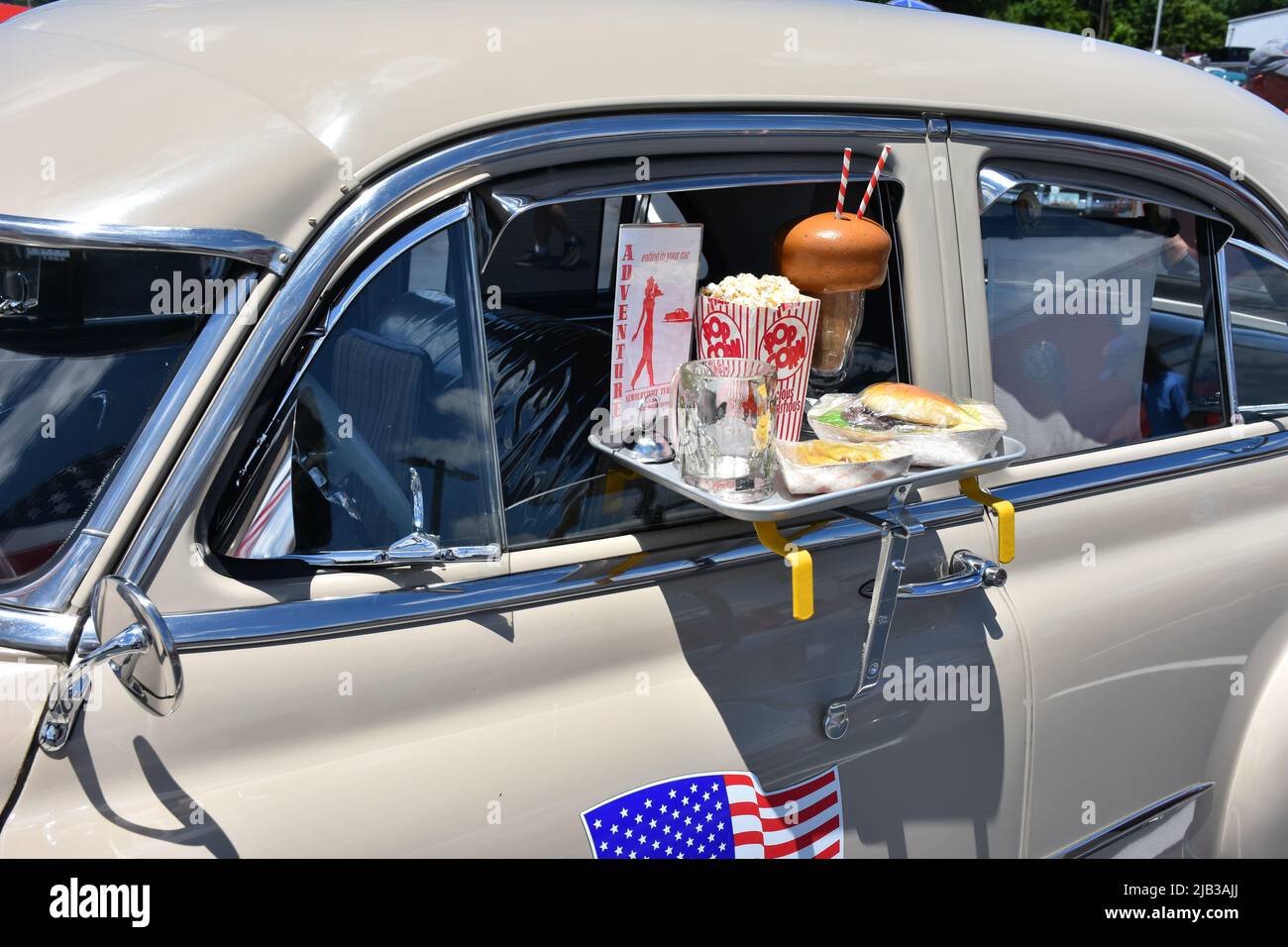 A 1951 Chevrolet with a window tray showing takeout in the 1950s. Stock Photo