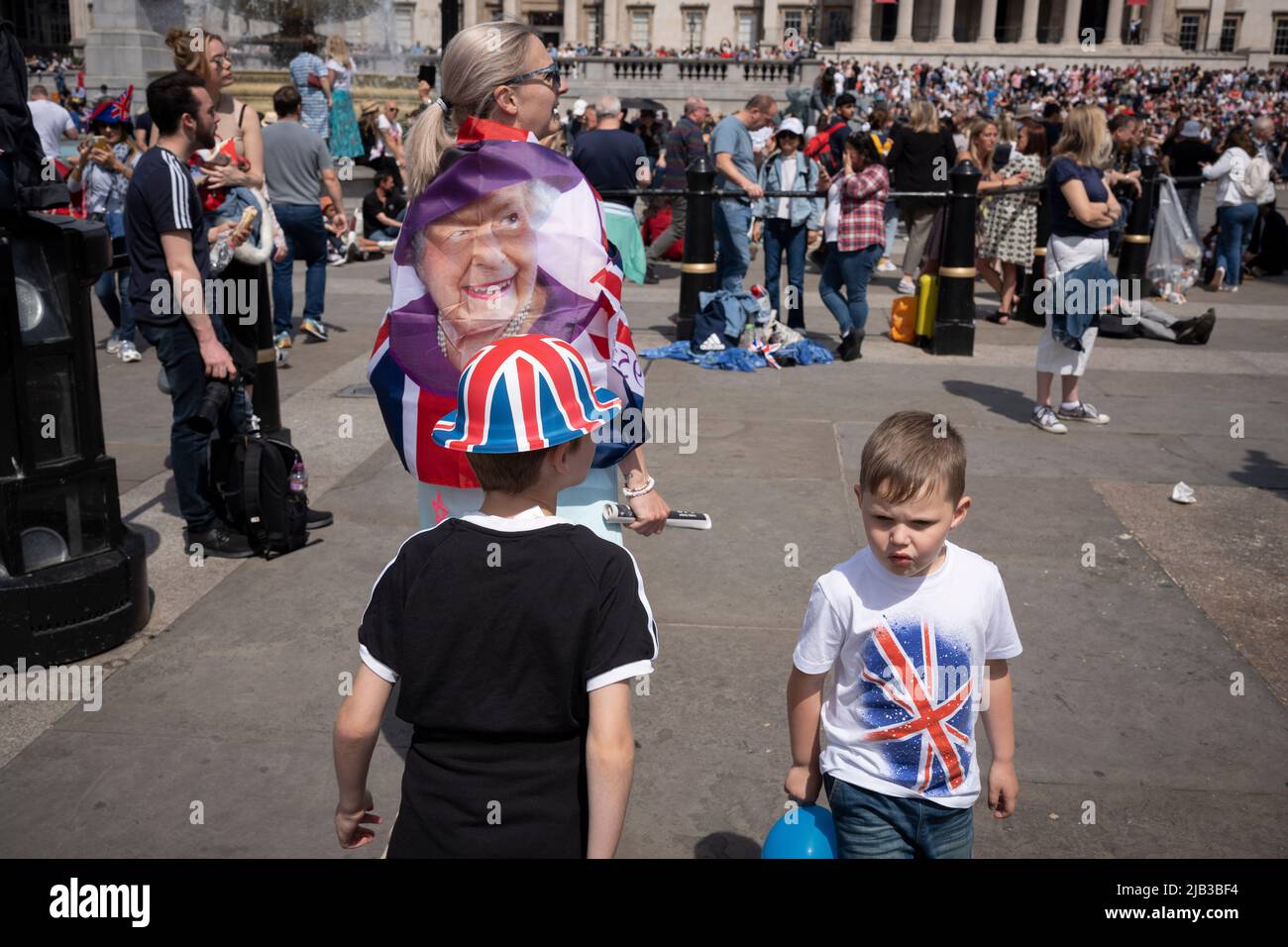 Unable to access the Mall and the Trooping of the Colour ceremonial event that coincided with the queen's Platinum Jubilee, Londoners gather in Trafalgar Square, on 1st June 2022 in London, England. Queen Elizabeth II has been on the UK throne for 70 years, the longest-serving monarch in English history and crowds flocked to central London to view this annual event during the Jubilee weekend. Tens of thousands however, were unable to view any of the ceremonial pageantry because the Mall was closed to more of the public by police, staying instead around surrounding streets and in Trafalgar Squa Stock Photo