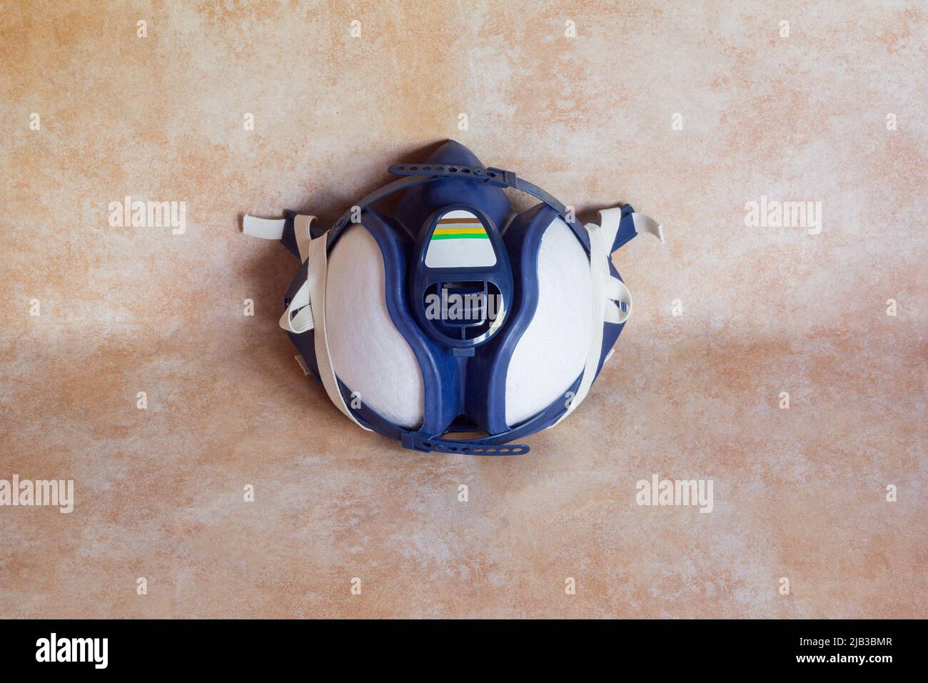 High angle shot of a half-face mask with filters on a studio background. Protective equipment and industry. Stock Photo
