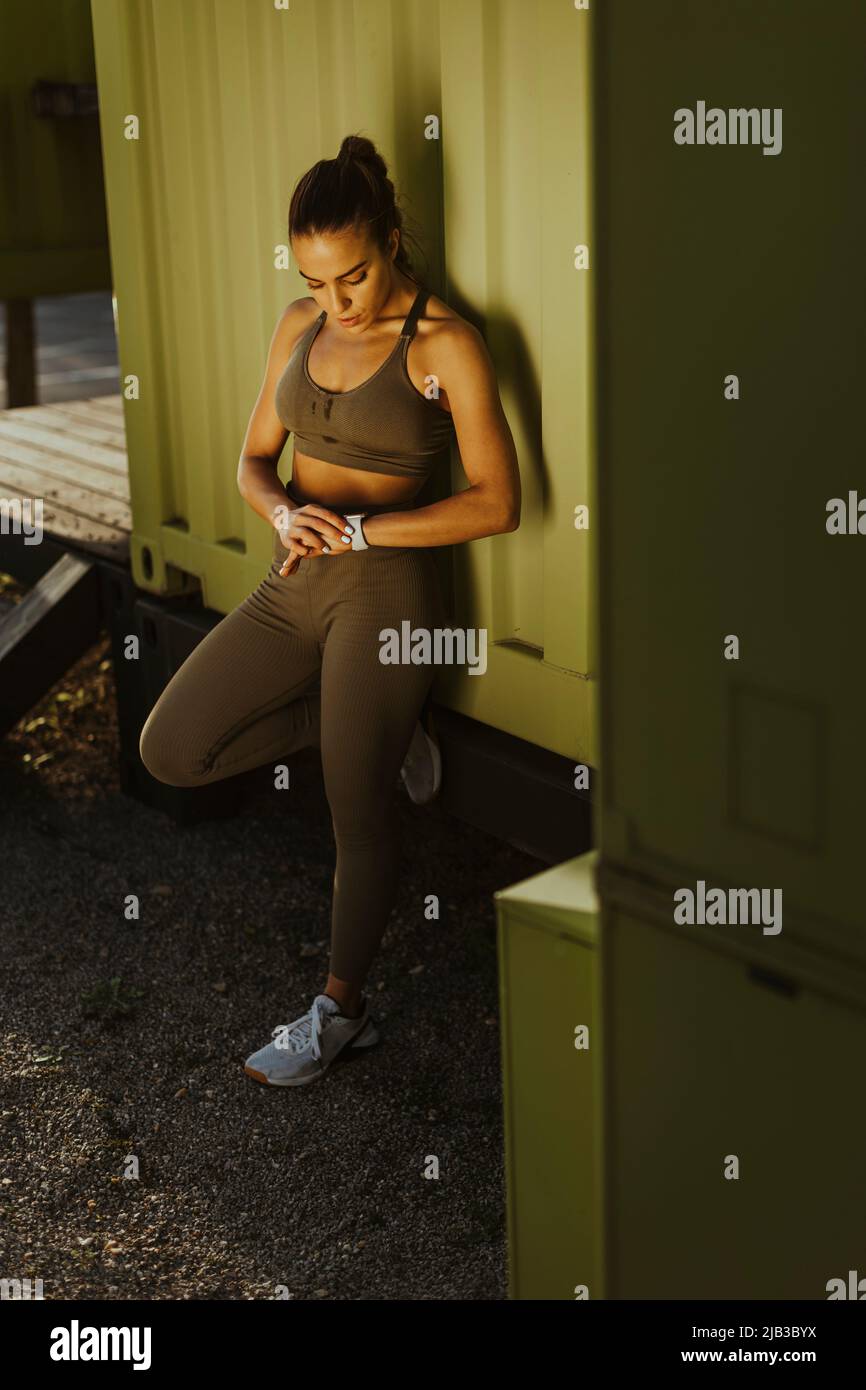 Pretty young woman takes a break after running in the urban area Stock ...