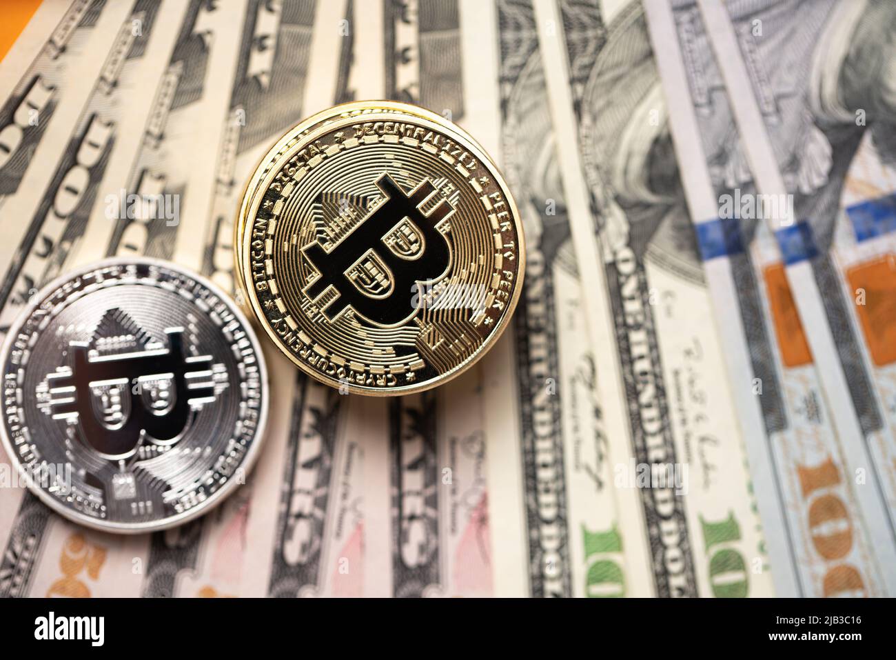 Piled up bitcoin coins on top of US dollar banknotes. Gold and silver BTC  coins. Crypto exchange to US dollar concept. Digital crypto currency with pa  Stock Photo - Alamy