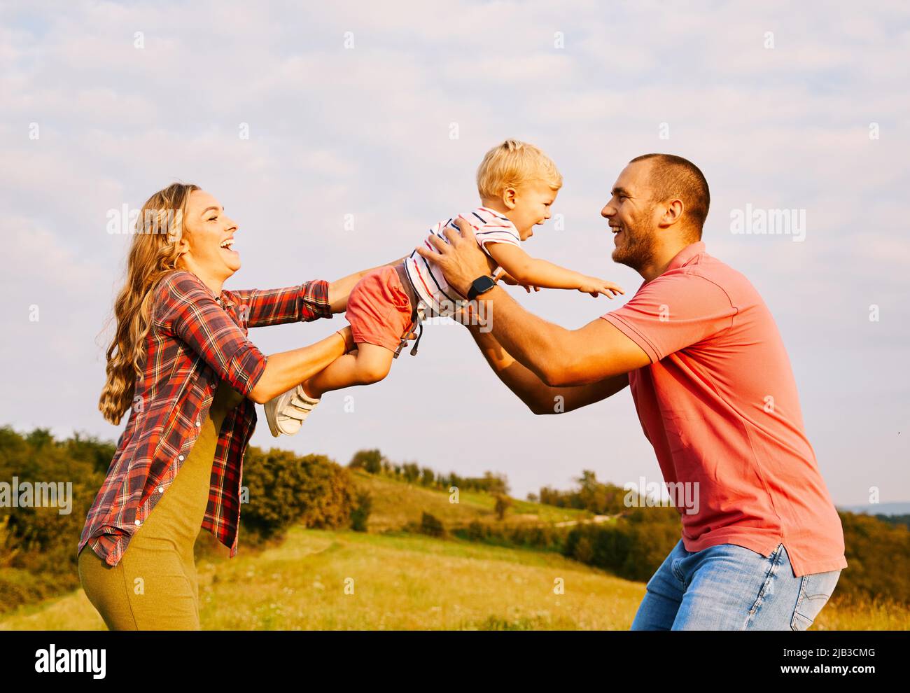 Portrait of a young happy family having fun outdoors Stock Photo