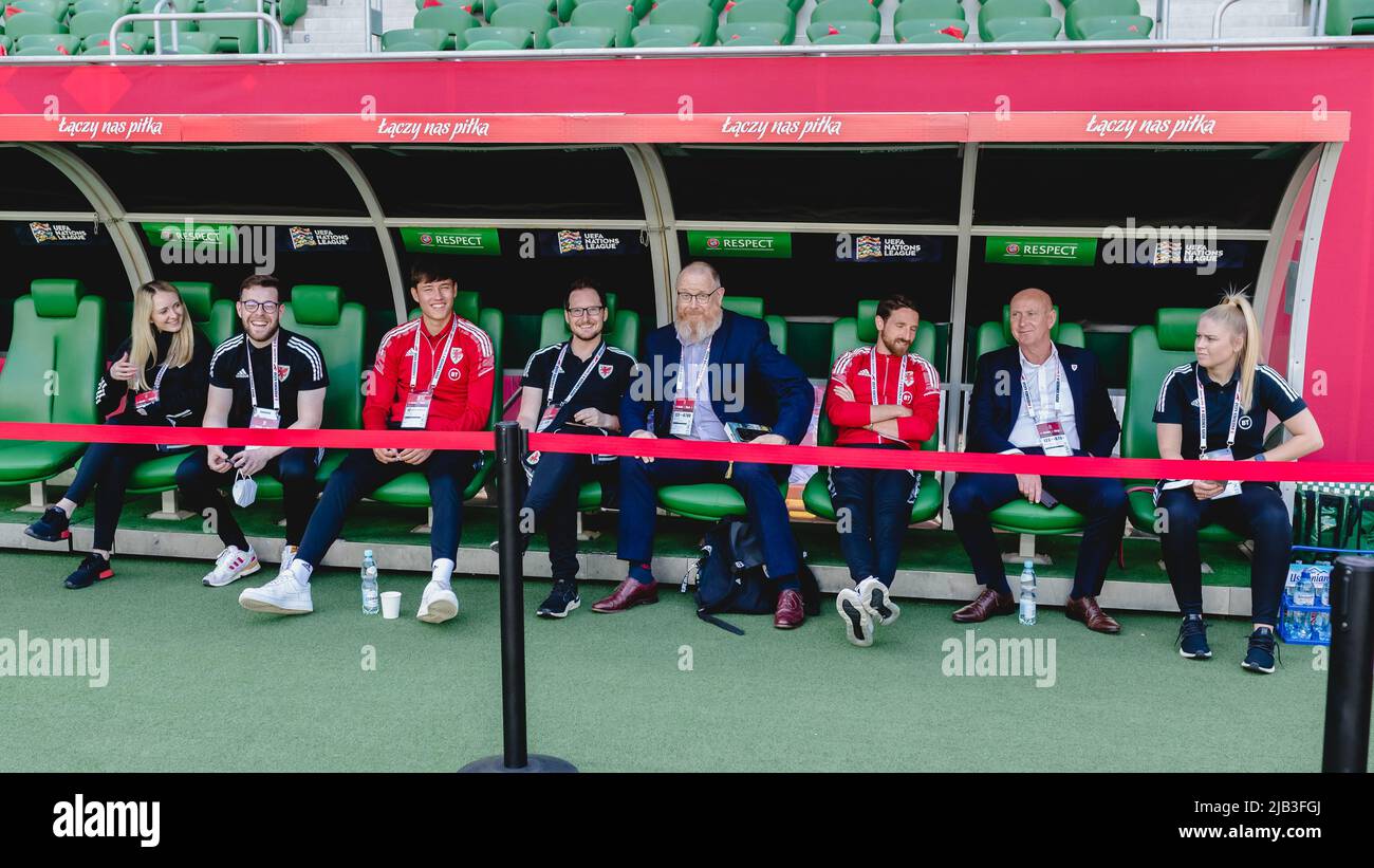 WROCŁAW, POLAND - 01 JUNE 2022: Wales’ Commercial Department Carys Price, Wales’ Team Operations Rhys Herbert, Wales' Rubin Colwill, Wales’ Media Officer Owain Harries, Wales’ Head of International Affairs Mark Evans, Wales' Joe Allen, Wales’ Media Officer Ian Gwyn Hughes and Siobhan Humphrey prior to the League A 2022 Nations League fixture between Poland & Wales at the Tarczynski Arena, Wrocław, Poland on the 1st of June, 2022. (Pic by John Smith/FAW) Stock Photo