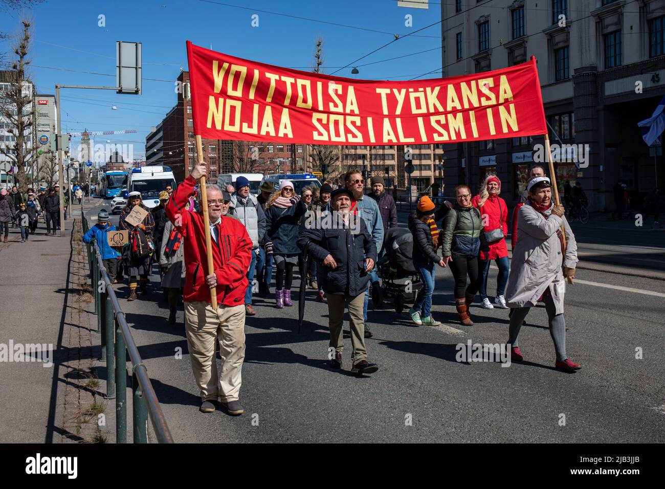 Voittoisa työkansa nojaa sosialismiin. Red banner at socialist May Day parade in International Workers' Day in Helsinki, Finland. Stock Photo