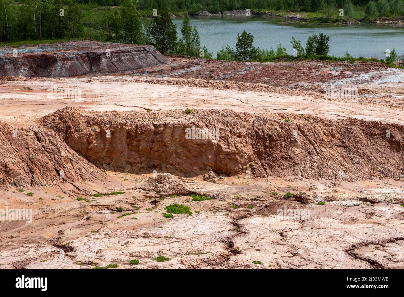 Red clay quarry. Clay quarry. Earth rocks are digging for building materials. Beautiful natural landscape to the land. Quarry with sand, sand loading, Stock Photo