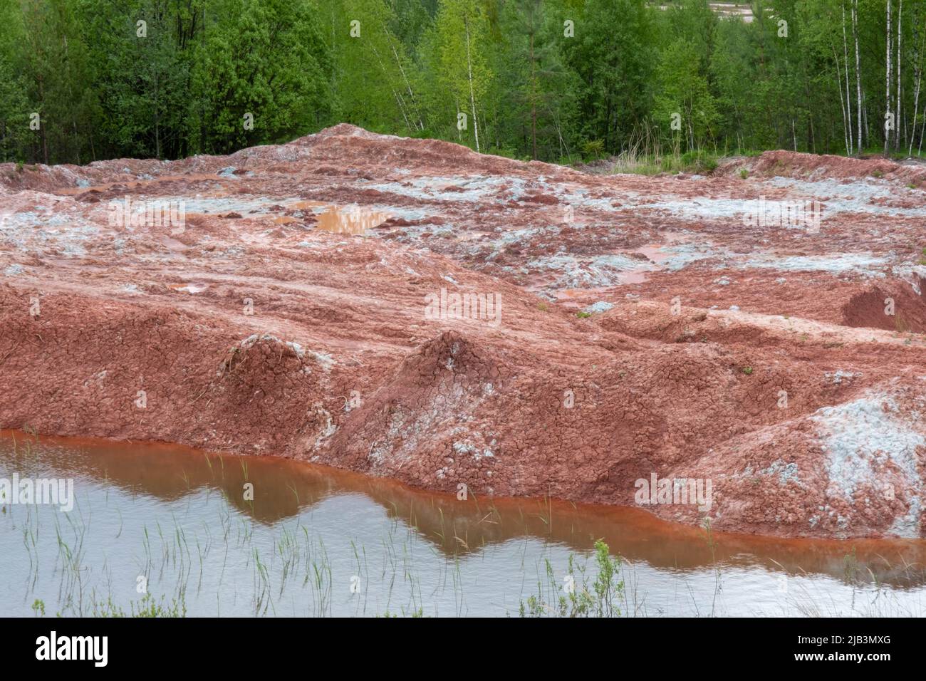 Red clay quarry. Clay quarry. Earth rocks are digging for building materials. Beautiful natural landscape to the land. Quarry with sand, sand loading, Stock Photo