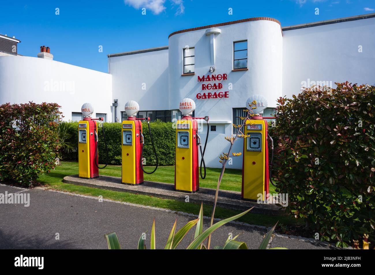 Manor Road Garage, Art Deco style apartments converted from restored 1930s petrol or fuel station with vintage fuel pumps in East Preston, England, UK Stock Photo